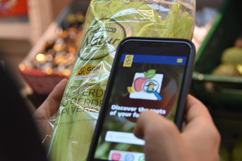 Image of a shopper checking a GGN number at an Eroski store in Spain